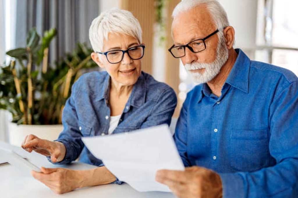 Engineers Meeting On Factory Floor Of Busy Engineering Workshop